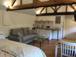 a living room with a couch and a table at The Stables At Harby in Melton Mowbray