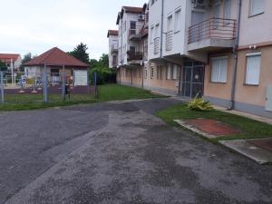 an empty street in front of a building at Gabrielle apartman in Hajdúszoboszló +7 photos