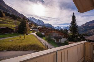 a view from a balcony of a village with mountains at Chalet Brunner 4 in Wengen