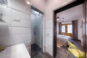 a bathroom with a shower and a bed in a room at En Suite Room Demaria in Komiža