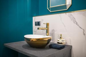 a bathroom with a bowl sink on a counter at Golden Moonlight in Zielona Góra