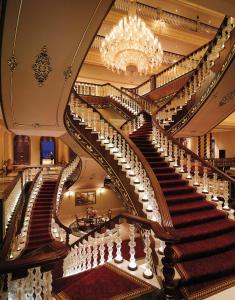 a large staircase in a building with a chandelier at Titanic Mardan Palace in Lara