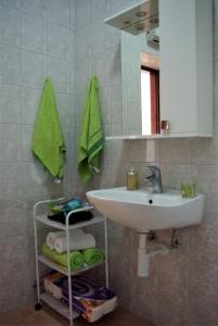 a bathroom with a sink and a mirror at Romantic Apartment In Nature in Borovići