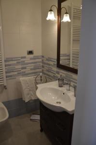 a bathroom with a sink and a mirror at Il Borgo Antico in Bisceglie
