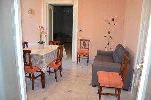 a living room with a table and a couch at Il Borgo Antico in Bisceglie +3 photos