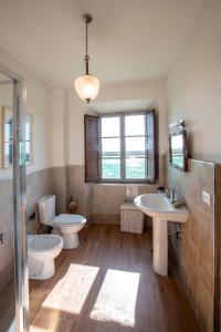 a bathroom with two toilets and two sinks and a window at Agriturismo Villa Cavallini in Camaiore +168 photos
