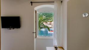 a room with a window with a view of the water at The Little Gem in Komiža