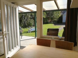 an open door to a patio with a view of a yard at Campinghütte in Fehmarn