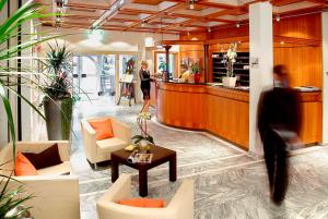 a woman walking through a lobby of a store at Hotel Sonnengarten in Bad Wörishofen