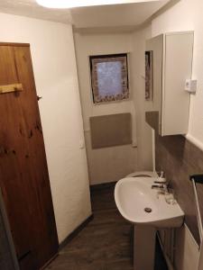 a bathroom with a white sink and a window at Appartement T2 quartier château de Pau in Pau