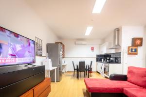 a living room with a couch and a flat screen tv at Rocky3 in Angra do Heroísmo