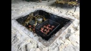 a fire pit with a bunch of chickens in it at Moorea Happy Bungalow in Teavaro