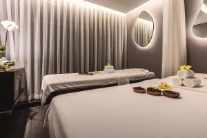 two beds in a room with towels and bowls of food at Stella Maris Beach Danang in Danang +70 photos