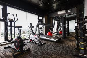 a gym with cardio machines and a window at Stella Maris Beach Danang in Da Nang