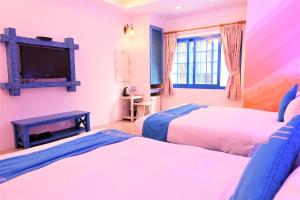Uma cama ou camas num quarto em Yujian Kending Tese Homestay