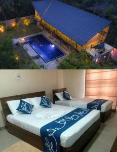 two beds in a room with a swimming pool at Honey Tree Polonnaruwa in Polonnaruwa