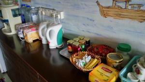 a counter top with a hair dryer and some food at Old Town Guest House in Malacca