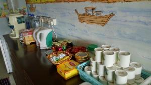 a counter with a bunch of paper cups on it at Old Town Guest House in Malacca