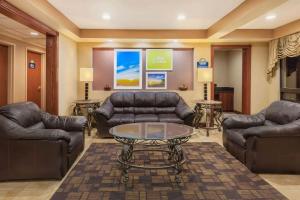 a waiting room with leather couches and a table at Days Inn by Wyndham Iselin / Woodbridge in Iselin