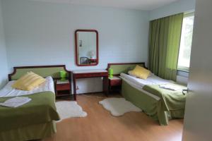 Ένα ή περισσότερα κρεβάτια σε δωμάτιο στο Laatokan Portti Apartments