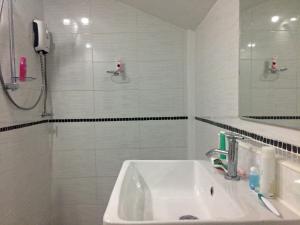 a white bathroom with a sink and a shower at Sunrise Villas Seaview in Ko Samed