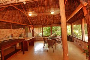 a dining room with a hammock in a hut at Hotel Boutique Casa Quetzal in Valladolid