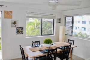 a dining room with a table and chairs at Kings Beach Retreat in Caloundra