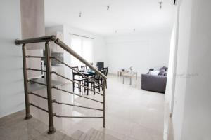 a spiral staircase in a living room with a couch at Aesthetic Apartments in Karpathos Town