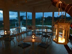 a room with tables and chairs and a large window at Casamediterranea in Sperlonga