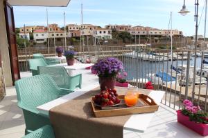 a tray of fruit on a table on a balcony at 103 Boutique Hotel Stintino in Stintino