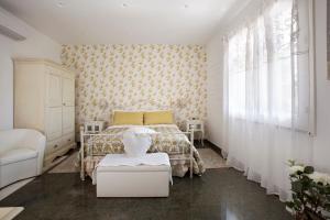 a white bedroom with a bed and a window at B&B Blanc Maison Etna Relais & Charme in Nicolosi