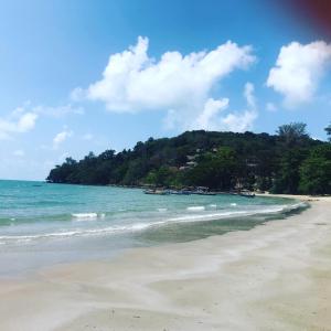 a beach with a group of boats in the water at Mae Phim, Rayong, Bali Residence Villa in Mae Pim