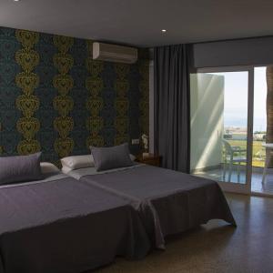 Łóżko lub łóżka w pokoju w obiekcie Hotel Salambina