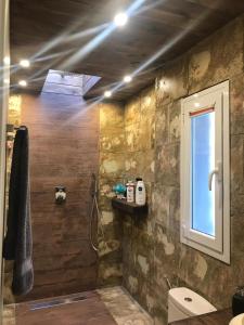 a bathroom with a sink and a shower with a window at Espacio Botavara in San José