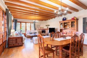 comedor con mesa y sala de estar en Home2Book Luxury Villa Luna de Tacoronte Pool, en La Laguna