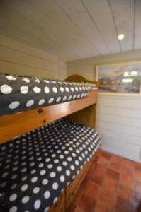 a room with two bunk beds with polka dot sheets at Rustic Log Cabin in Greencastle