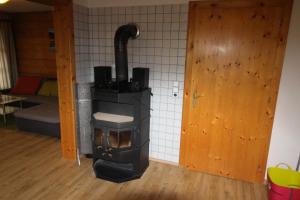 a stove in the corner of a room at Ferienwohnung Langwallner in Grossarl