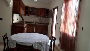 a kitchen with a table with a white table cloth on it at Faridi vacancy appartment in Casablanca