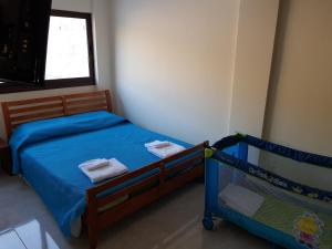 a bedroom with two bunk beds and a window at JOANNA SUNSET APTS Pomos in Pomos