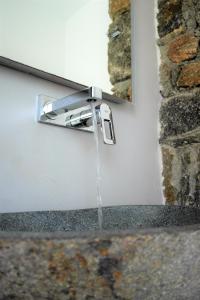 a stream of water coming out of a water fountain at Mykonos Pantheon in Kalo Livadi