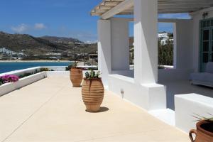 a row of vases on a balcony with a view at Mykonos Pantheon in Kalo Livadi