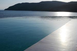 a view of a body of water with mountains in the background at Mykonos Pantheon in Kalo Livadi