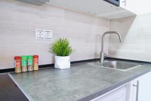 A kitchen or kitchenette at MalagaUrbanRooms - Beach & Sea