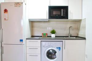 A kitchen or kitchenette at MalagaUrbanRooms - Beach & Sea