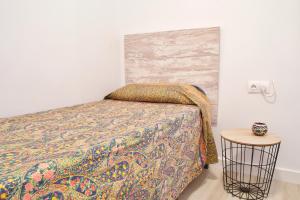 A bed or beds in a room at MalagaUrbanRooms - Beach & Sea