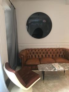 a living room with a brown couch and a table at Suites Menaggio in Menaggio