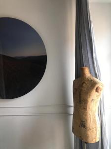 a vase sitting next to a wall with a mirror at Suites Menaggio in Menaggio