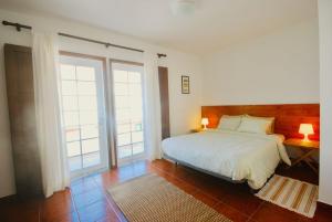 a bedroom with a bed and a large window at Casa Paulo - Baleal beach, Terrace in Baleal