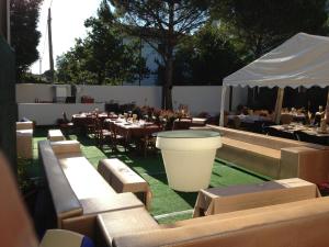 a restaurant with tables and chairs and a white tent at Albergo Cristallo in Cittiglio