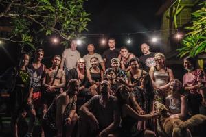 a group of people posing for a picture at night at Da Housetel Kuta in Kuta